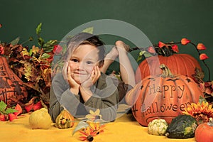 Cute boy and halloween pumpkins