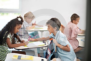 Cute boy helping his friend with difficult math test