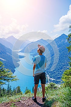 Cute boy with hiking equipment in the mountains