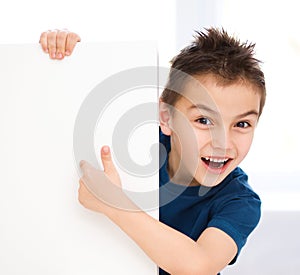 Cute boy is holding blank banner