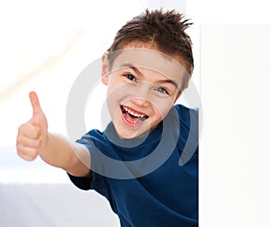 Cute boy is holding blank banner