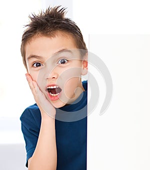 Cute boy is holding blank banner