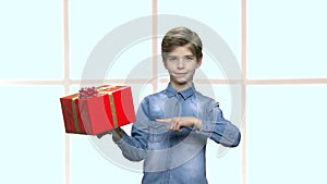 Cute boy holding box with present.