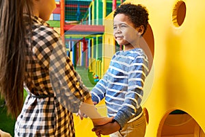 Cute Boy Holding Hands with Girl on Playground