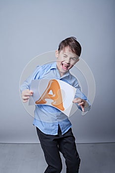 Cute boy holding shit with a letter