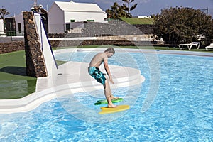 Cute boy jumping in the pool