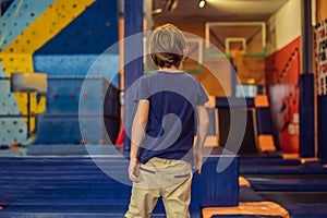 Cute boy jumping on trampoline in entertainment center