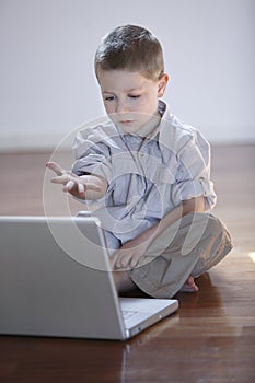 Cute boy with laptop computer