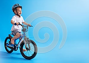 Cute boy learing how to ride a bike