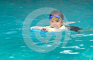 Cute boy learning to swim