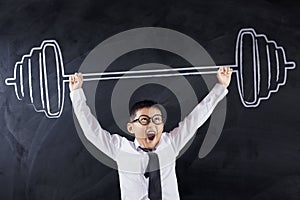 Cute boy lifting dumbbell