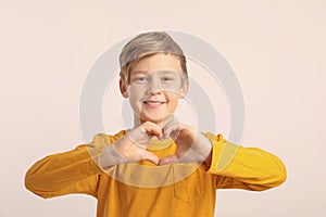 Cute boy making heart with his hands