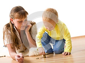 Cute boy with mother learn to count money at home