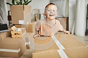 Cute Boy Moving Boxes in New Home