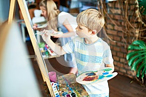 Cute Boy Painting in Art Class