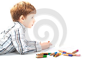 Cute boy painting on a white paper