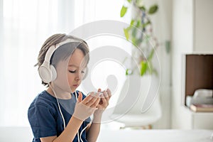 Cute boy with phone and head phones, listening music