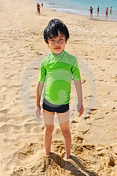 Cute boy playing on the beach