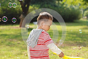 Cute boy playing bubbles