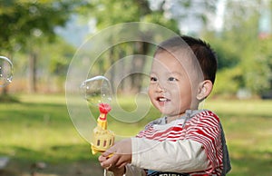 Cute boy playing bubbles