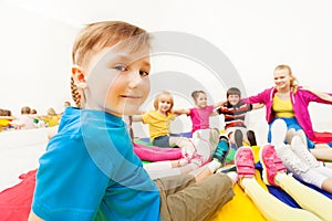 Cute boy playing circle games with friends in gym