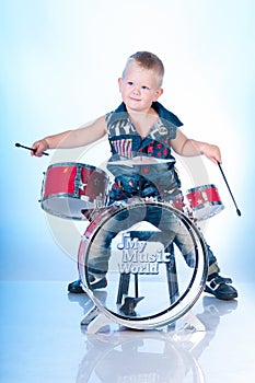 Cute boy playing the drums
