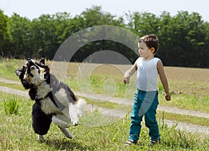 Cute boy playing fetch with his dog