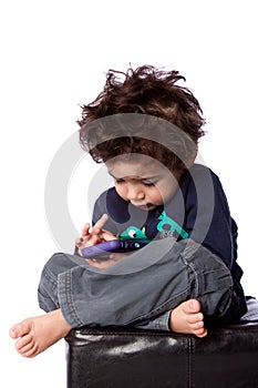 Cute boy playing games on mobile device