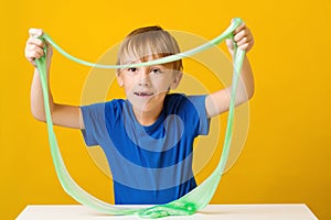 Cute boy playing with popular slime. Cute boy doing experiment scientific method