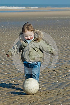 Cute boy playing soccer