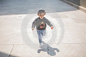 Cute boy playing on the streets of the metropolis