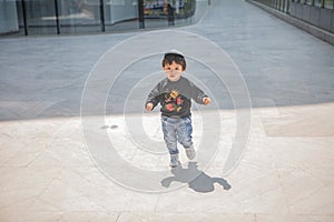 Cute boy playing on the streets of the metropolis