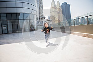 Cute boy playing on the streets of the metropolis