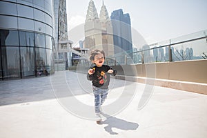 Cute boy playing on the streets of the metropolis