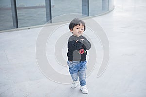 Cute boy playing on the streets of the metropolis