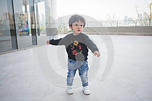 Cute boy playing on the streets of the metropolis