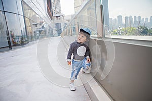 Cute boy playing on the streets of the metropolis