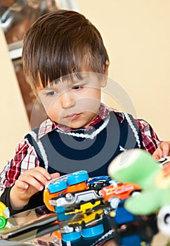 Cute boy playing with toys