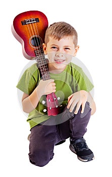 Cute boy playing the ukulele guitar