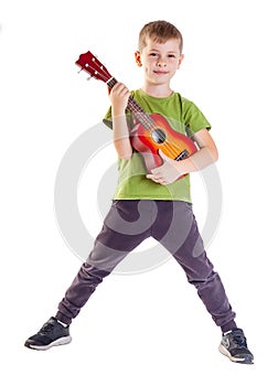 Cute boy playing the ukulele guitar