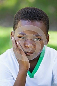 Cute boy pouting at the camera in the park