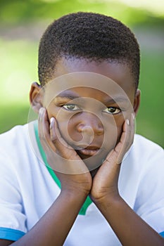 Cute boy pouting at the camera in the park