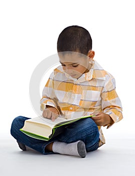 Cute boy reading a book