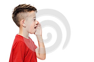 Cute boy in red T-shirt shouting. Speech therapy concept over white background. Side view.