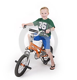 A cute boy riding his bike isolated on white background