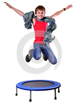 Cute boy with scarf exercising and jumping on a trampoline