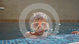 cute boy in a scuba diving mask is swimming in pool. Summer holidays. Rest at the hotel. School holidays. A child on the