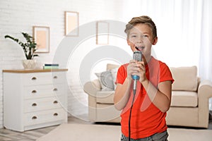 Cute boy singing in microphone