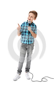 Cute boy singing in microphone on white
