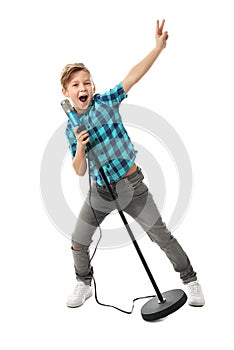 Cute boy singing in microphone on white